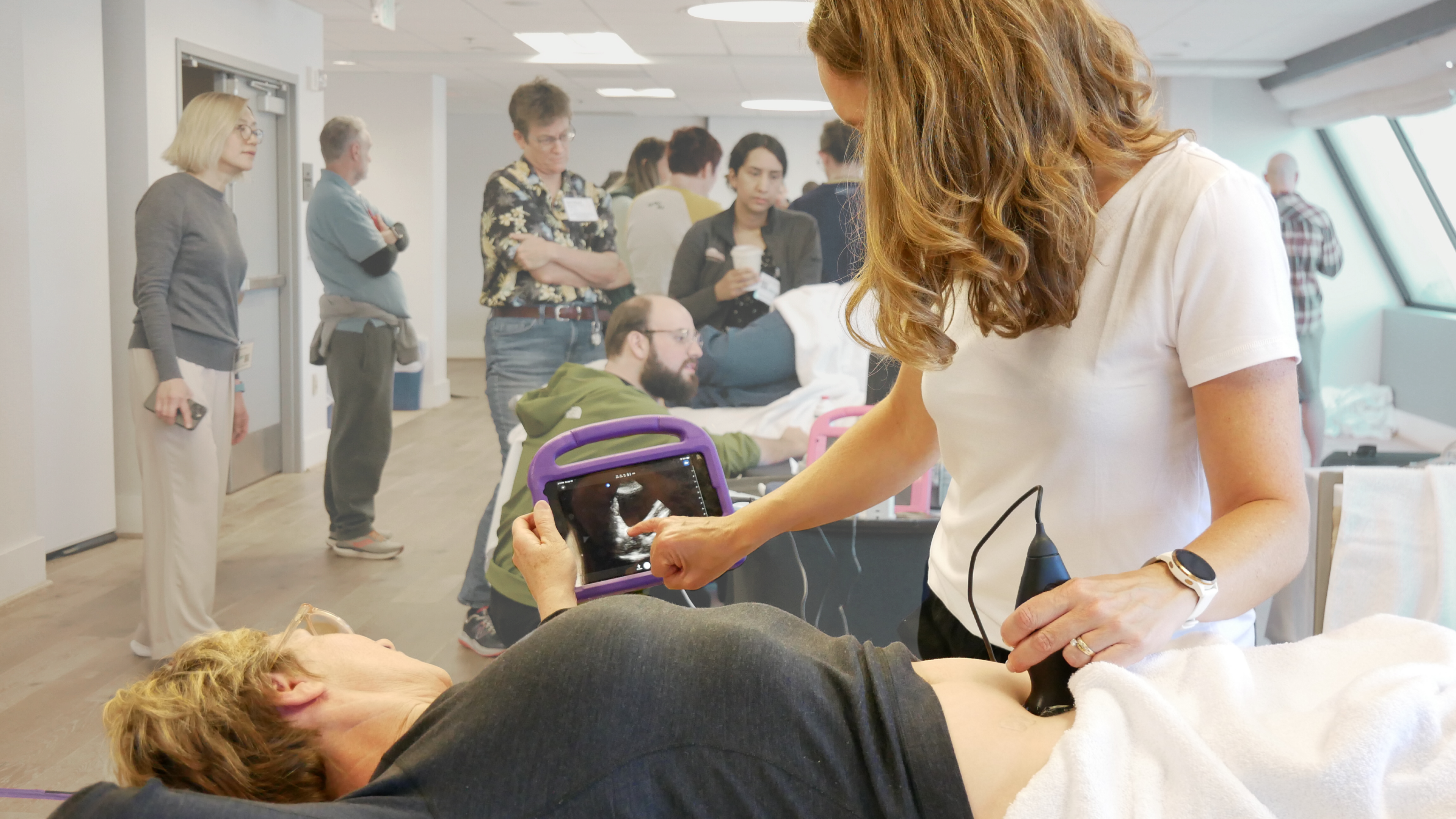 Clinician holding a probe during a scanning session at GUSI’s San Francisco hands-on POCUS training for primary care.